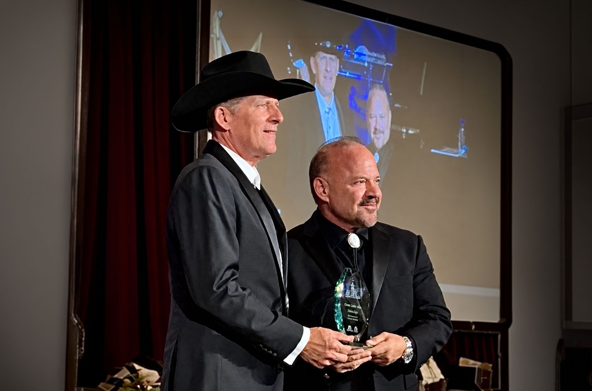 Anthony Paterra, founder of Paterra Custom Homes, and Scott Clere, vice president and co-owner of Paterra Custom Homes, accept one of the company’s four Sand Dollar Awards at the 2026 Sand Dollar Awards presented by the Collier Building Industry Association.